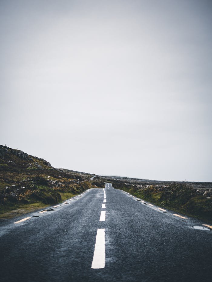 Discover the serene beauty of an empty road stretching into the horizon in County Donegal, Ireland.